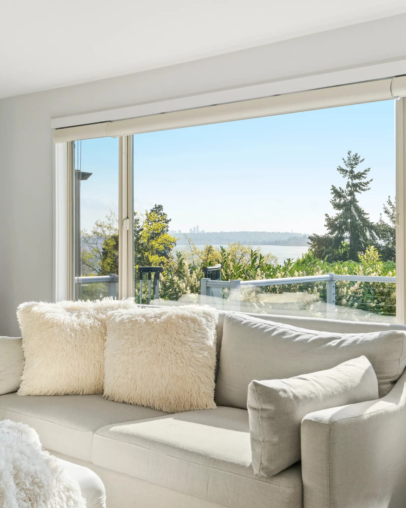 Prepared living room with a wide window overlooking the water