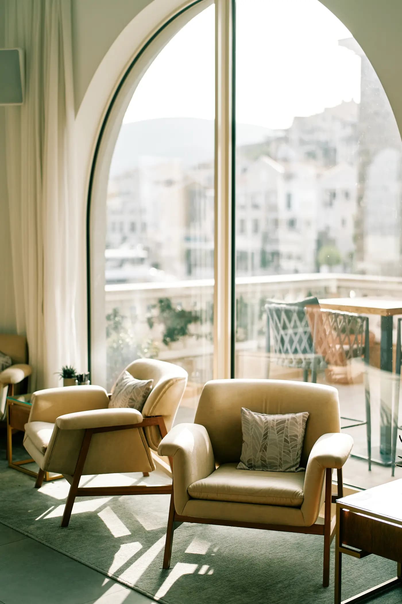 Sunlit Greek interior looking towards a neighbourhood balcony